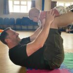 dad and baby balancing